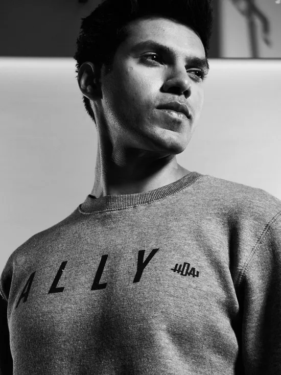 Stylish advocate: A man confidently models the Hockey Diversity Alliance Ally sweater, supporting inclusivity and unity in the hockey community.